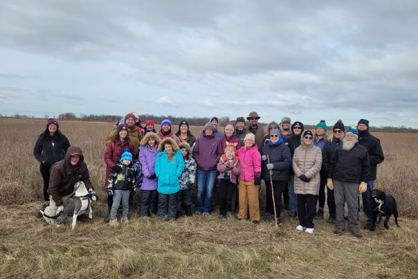 A group bundled up for the cold stands together and smiles