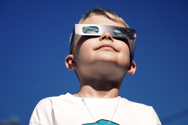 Boy wearing eclipse safety glasses