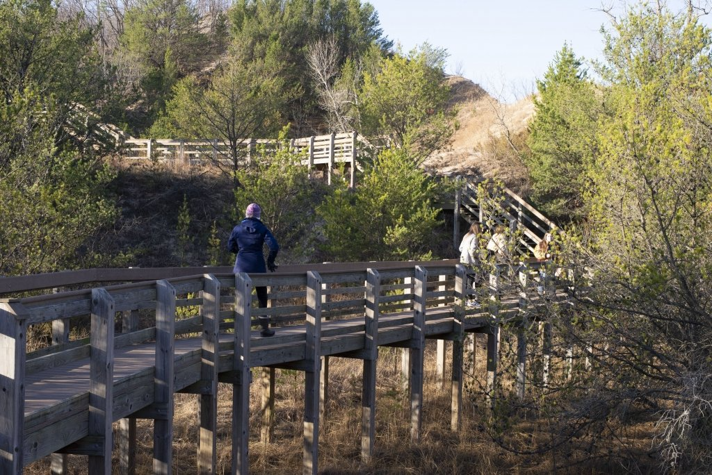 Hikers on a dune boardwalk trail
