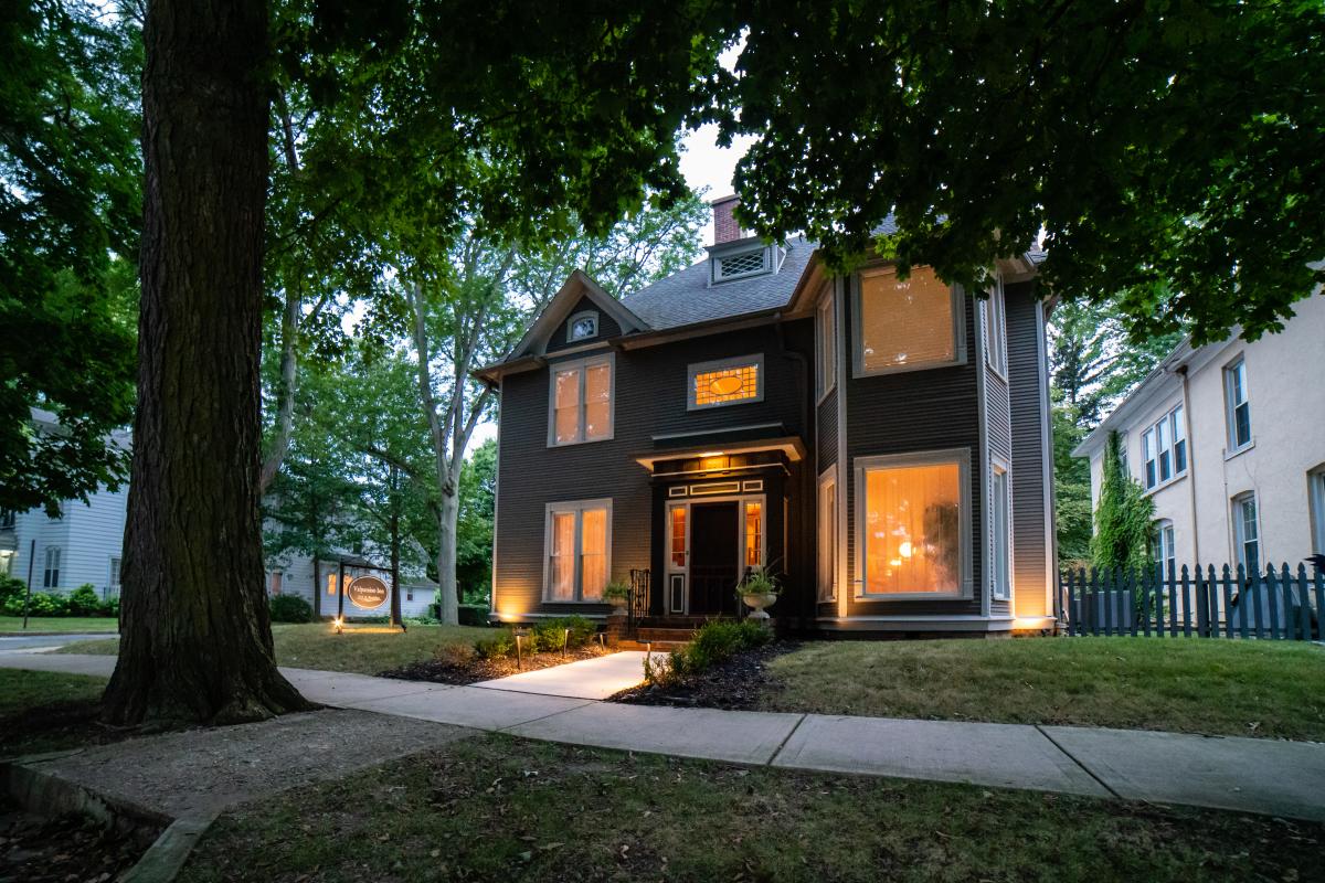 Windows glow with light on a house turned bed and breakfast.