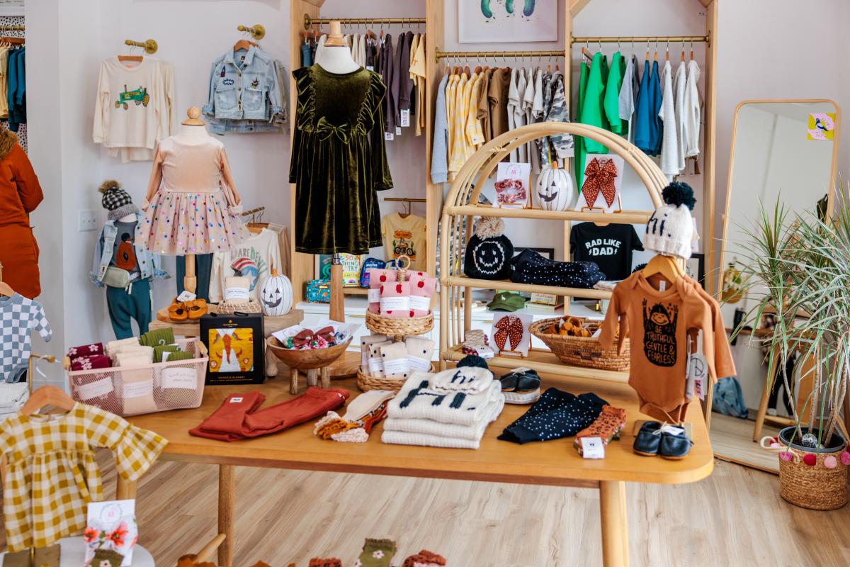 An in-store table display of clothes for children.