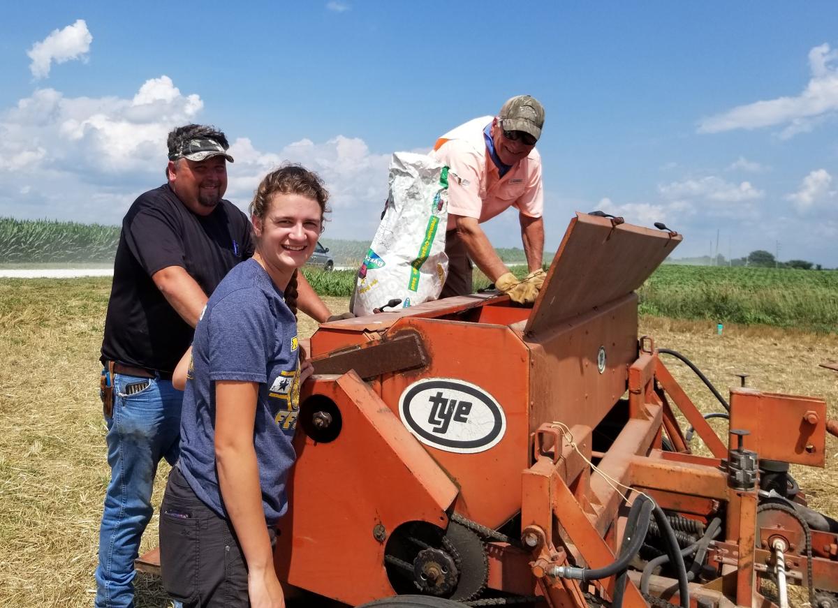 Summer 2023 Intern Madelyn Arrenholz (front) assisting with cover crop planting on ag ground.