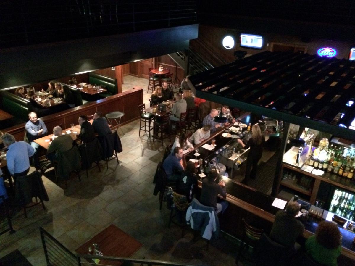 A view of a bar from above. People are sitting at a square bar