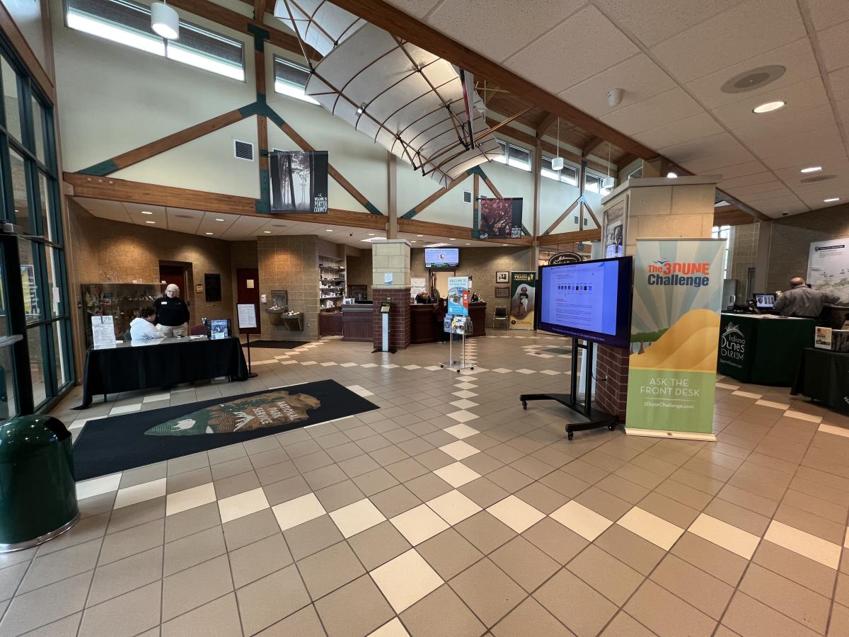 Interior shot of a public building. A vintage glider hangs from the ceiling.