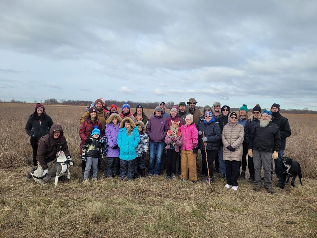 A group bundled up for the cold stands together and smiles