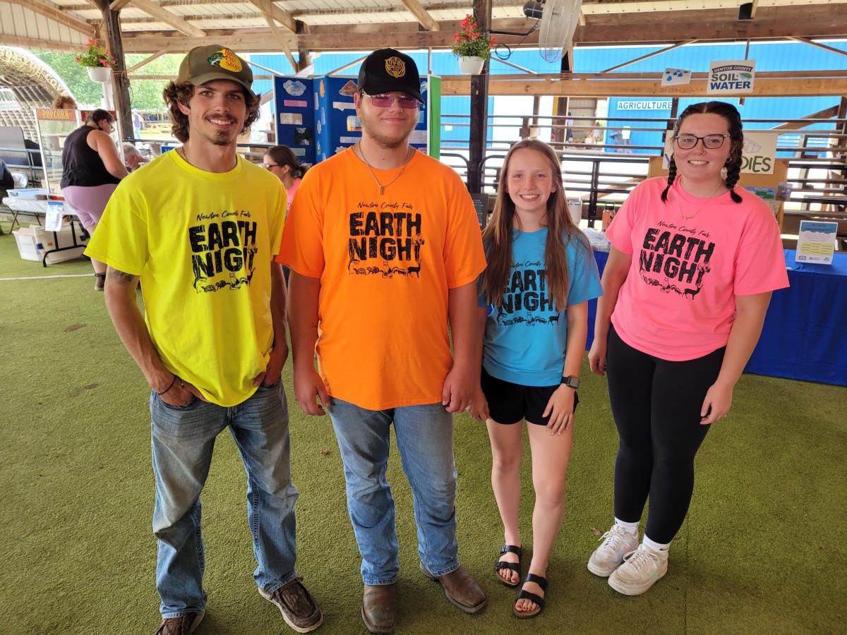 Summer 2024 Interns River Smart, Sam Lipsky, Dakota Dyer and Shaylee Marks at the Newton County Fair Earth Night.