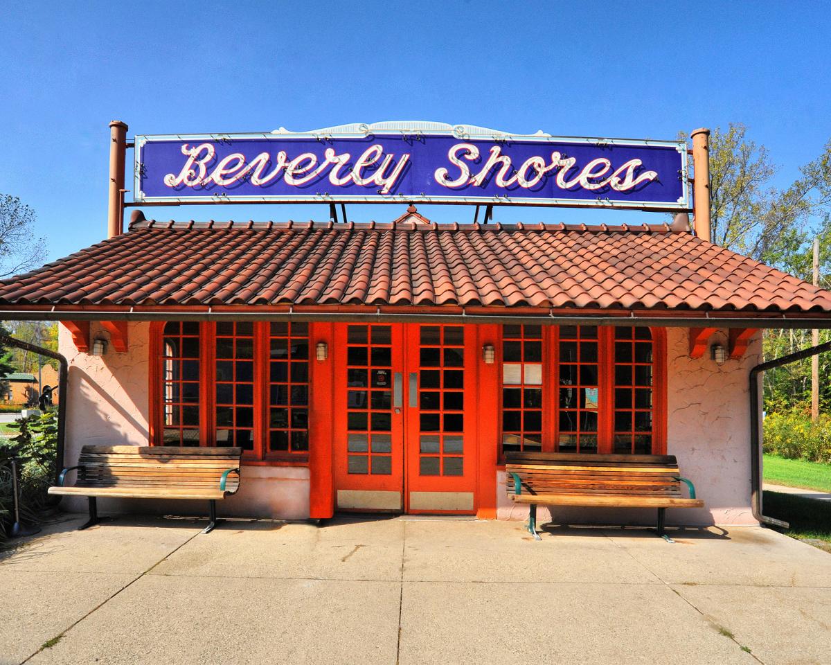 Beverly Shores historic train depot with orange Spanish-style architecture and Beverly Shores signage surrounded by trees