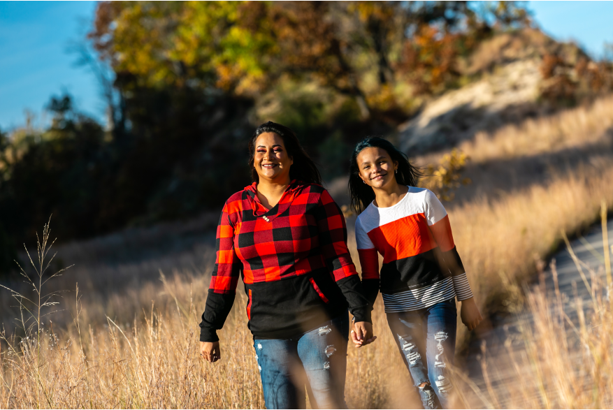 A mother and child hike in the fall.
