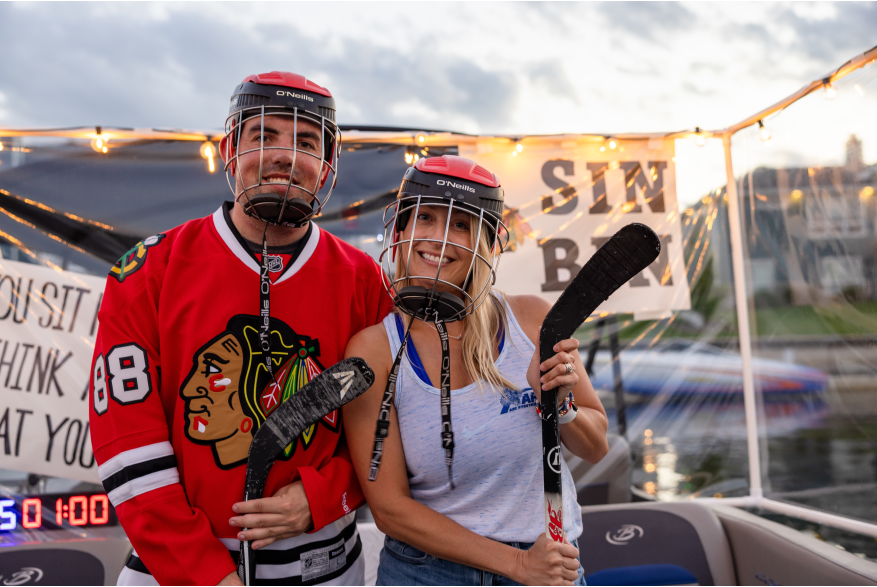 A man and woman are dressed in hockey gear for the picture.