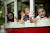 kids waving from the streetcar windows