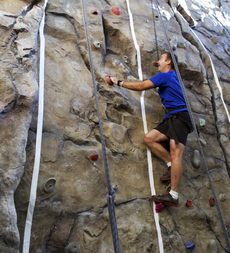 Man on the rock climbing wall at the YMCA
