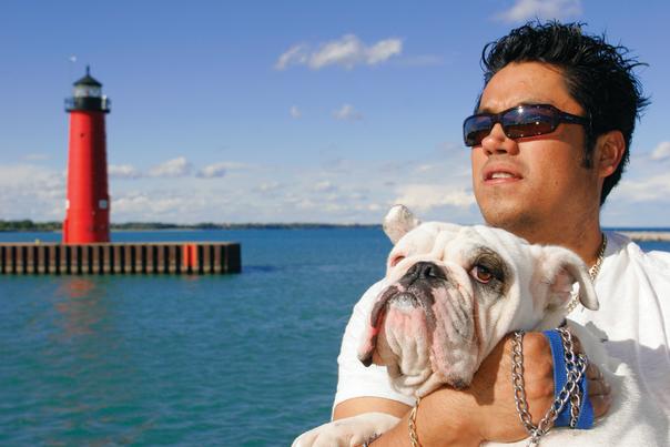 Man & dog with North Pier Lighthouse in the background