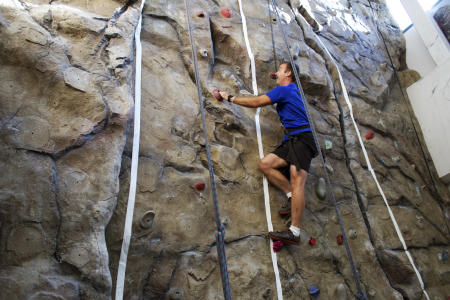 Man on the rock climbing wall at the YMCA