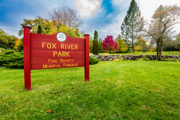 Entrance to Fox River Park with the park sign and autumn colors