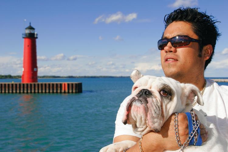 Man & dog with North Pier Lighthouse in the background