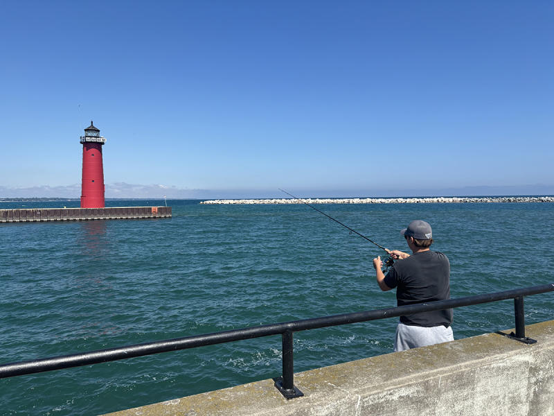 fishing at Kenosha harbor, North Pier Lighthouse shown