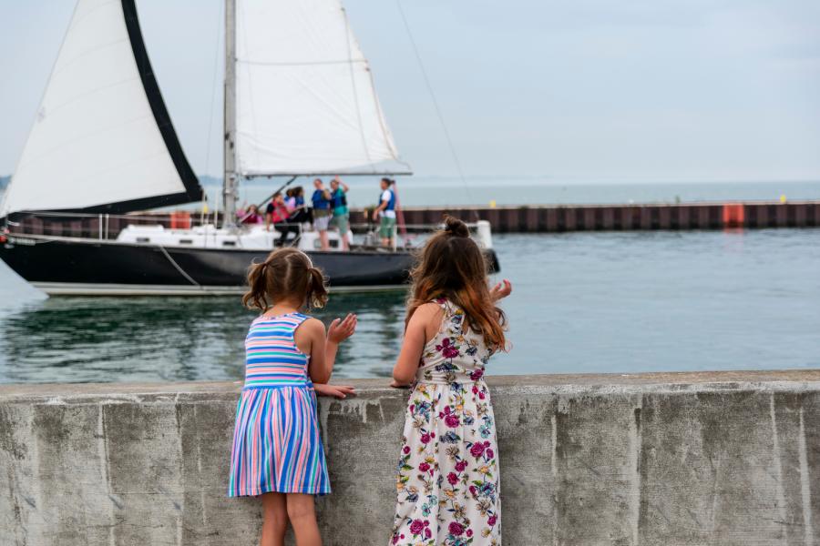 kids waving to boat in the Kenosha harbor