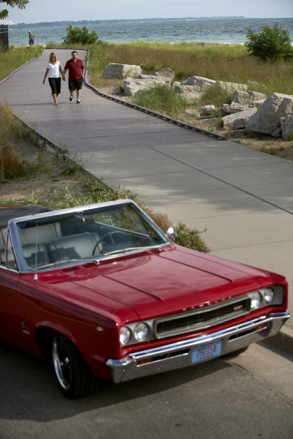 Couple Holding Hands & Red Convertible