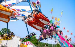 Lackawanna County Heritage Fair Scranton, PA, swing ride, carnival fun slide with a blue sky in the background.