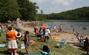 People on the beach and swimming at Merli-Sarnoski Park