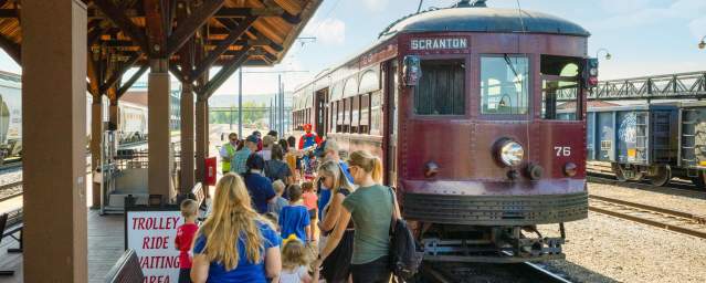 people standing at the boarding station of the Electric City Trolley Station & Museum in Scranton, PA