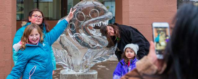 People posing for pics in front of sculptures at the Clarks Summit Festival of Ice