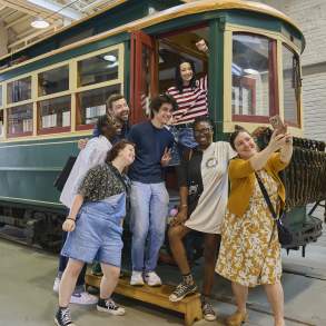 A group of people taking a selfie on a trolley car at the Electric City Trolley Station & Museum in Downtown Scranton, PA