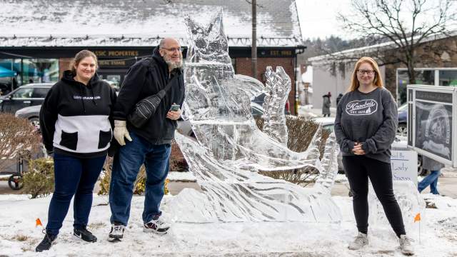 A family posing next to an ice sculpture at the Clarks Summit Festival of Ice in Clarks Summit, PA