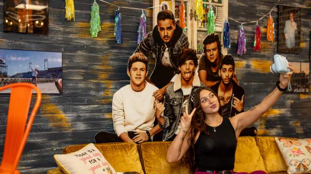 Girl taking a selfie on a golden couch at Lucca Fresca in Taylor, PA