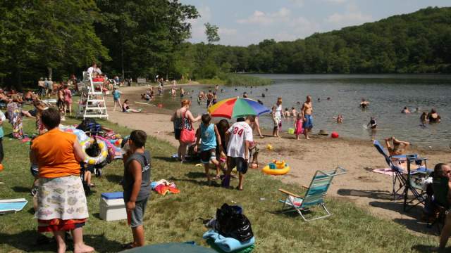 People on the beach and swimming at Merli-Sarnoski Park