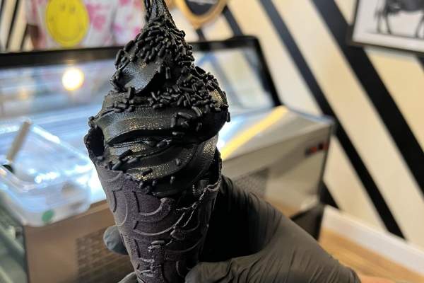 Black Cow Cookies & Cream on top of a black cone.