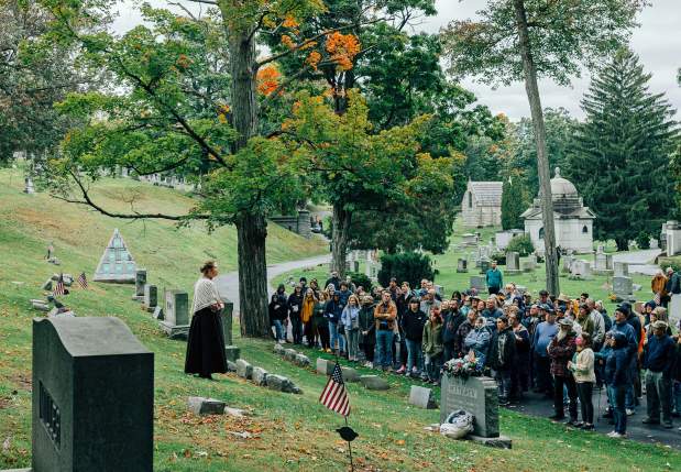 Visitors watching a historical performance during the Dunmore Cemetery Tour