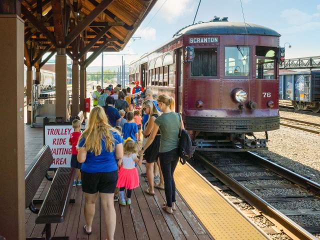people standing at the boarding station of the Electric City Trolley Station & Museum in Scranton, PA