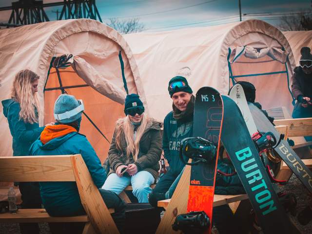 snowboarders sitting around a fire pit at Midland at Montage Mountain Resorts in Scranton, PA