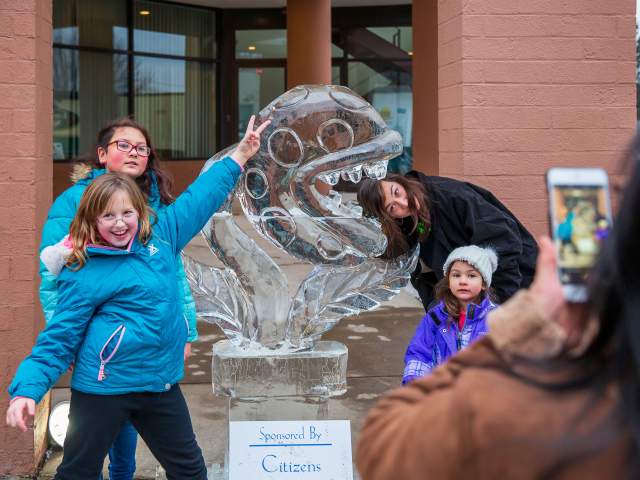 People posing for pics in front of sculptures at the Clarks Summit Festival of Ice