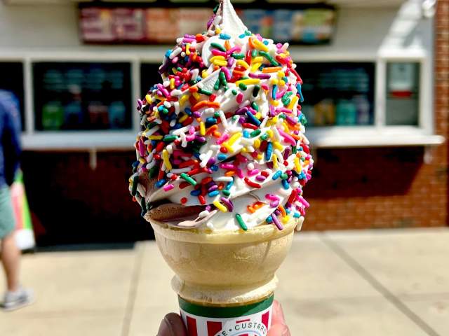 A cone of frozen custard with rainbow sprinkles at Rita’s Italian Ice & Frozen Custard in Dunmore, PA