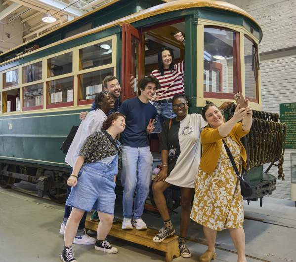A group of people taking a selfie on a trolley car at the Electric City Trolley Station & Museum in Downtown Scranton, PA