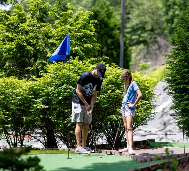 A father and child playing mini golf at Lahey Family Fun Park in Clarks Summit, PA