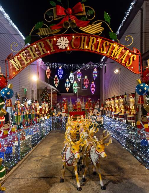 View at night with festive holiday lights illuminating the Christmas Lights House in Scranton, PA.