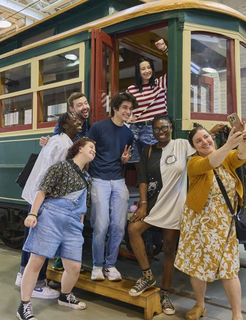 A group of people taking a selfie on a trolley car at the Electric City Trolley Station & Museum in Downtown Scranton, PA