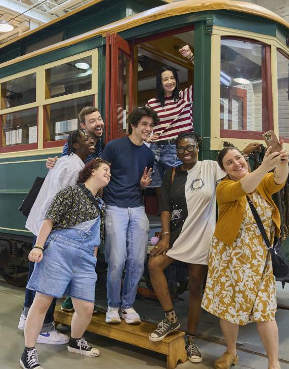 A group of people taking a selfie on a trolley car at the Electric City Trolley Station & Museum in Downtown Scranton, PA