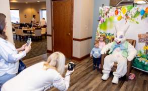 Parents taking photos of their children with the Easter Bunny at the Hilton Scranton & Conference Center.