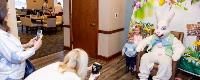 Parents taking photos of their children with the Easter Bunny at the Hilton Scranton & Conference Center.