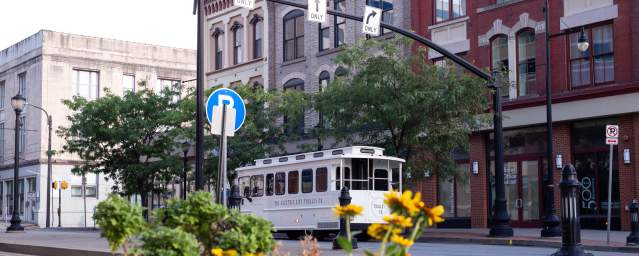 The Electric City Trolley Co trolley bus driving down a street in Downtown Scranton