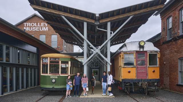 People standing in front of vintage trolleys at the Electric City Trolley Station Museum in Scranton, PA