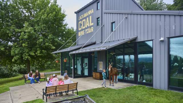 A group of people outside the Lackawanna Coal Mine Tour in McDade Park in Scranton, PA