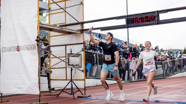 Race participants taking selfie while crossing the finish line at the Scranton Half Marathon