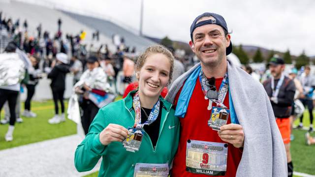 Race participants holding their finisher medals at the Scranton Half Marathon