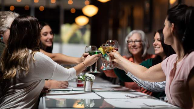 Women raising cocktails in a cheerful toast inside Alfredo’s Café in Scranton, PA.