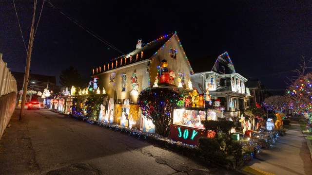 The Holiday House on Moosic Street in Scranton, PA at night, decorated with festive Christmas lights.